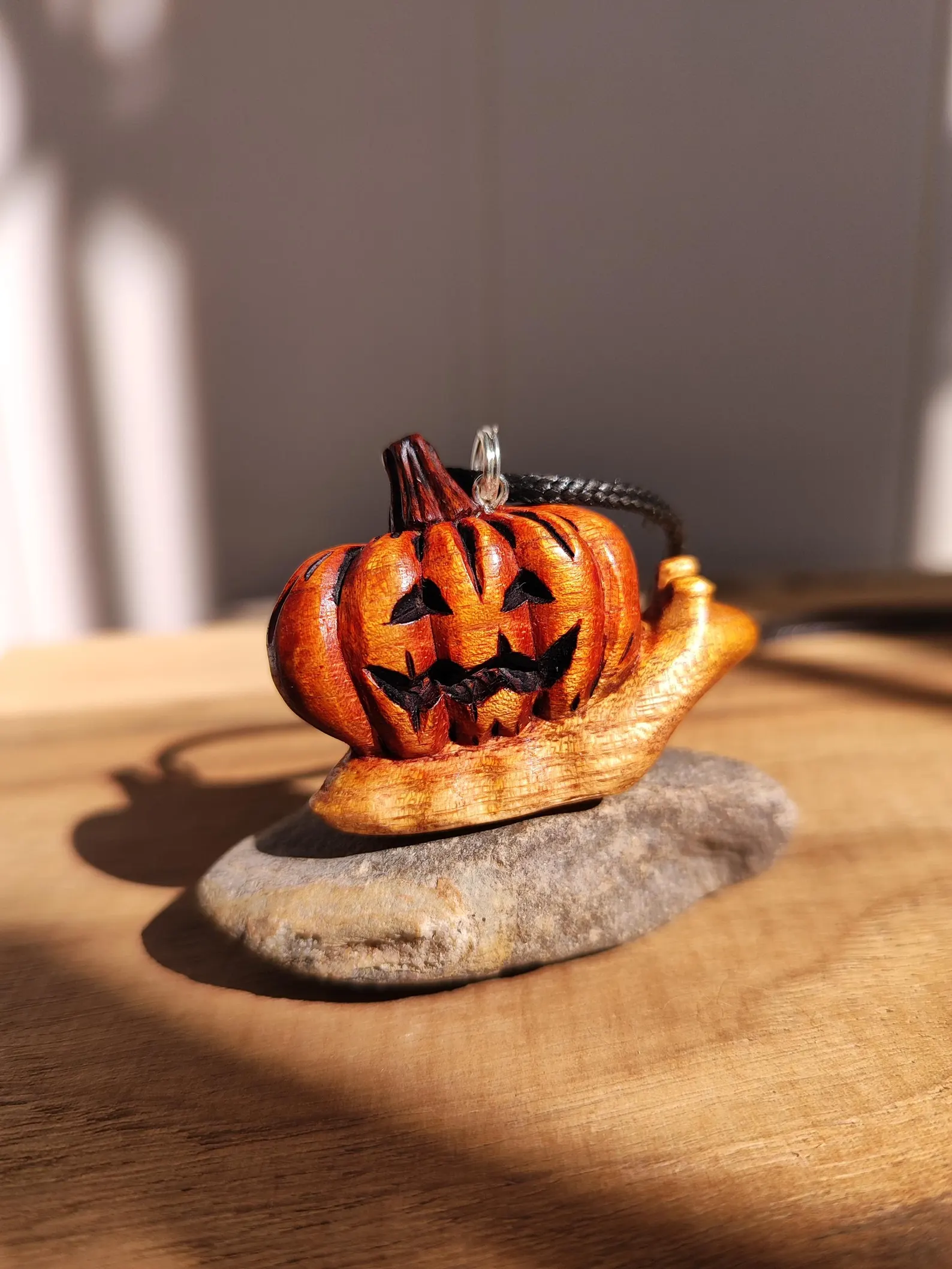 Snail jack-o’-lantern necklace